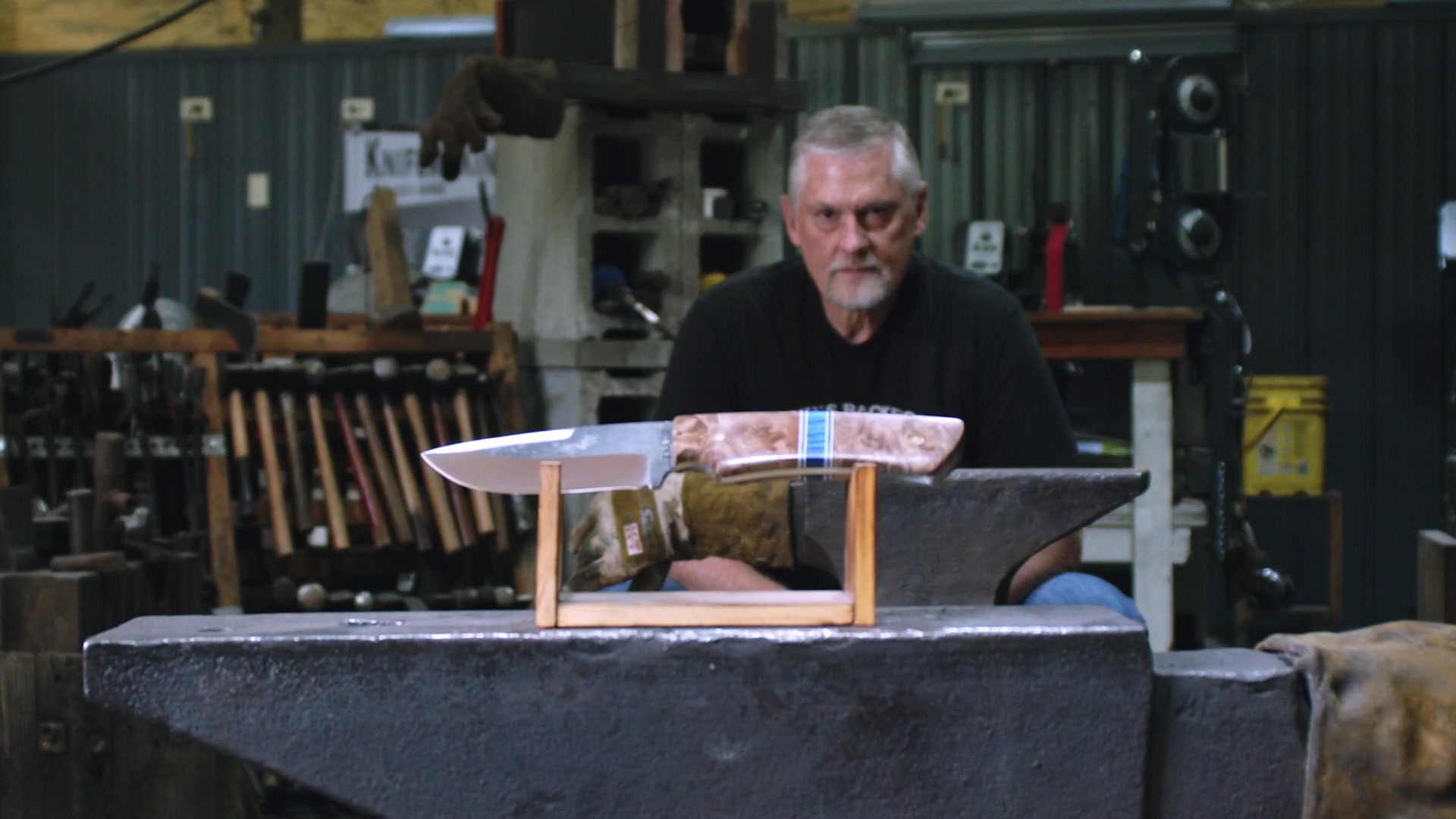 Bobby Walker behind a finished knife in the forge, from the final campaign film.
